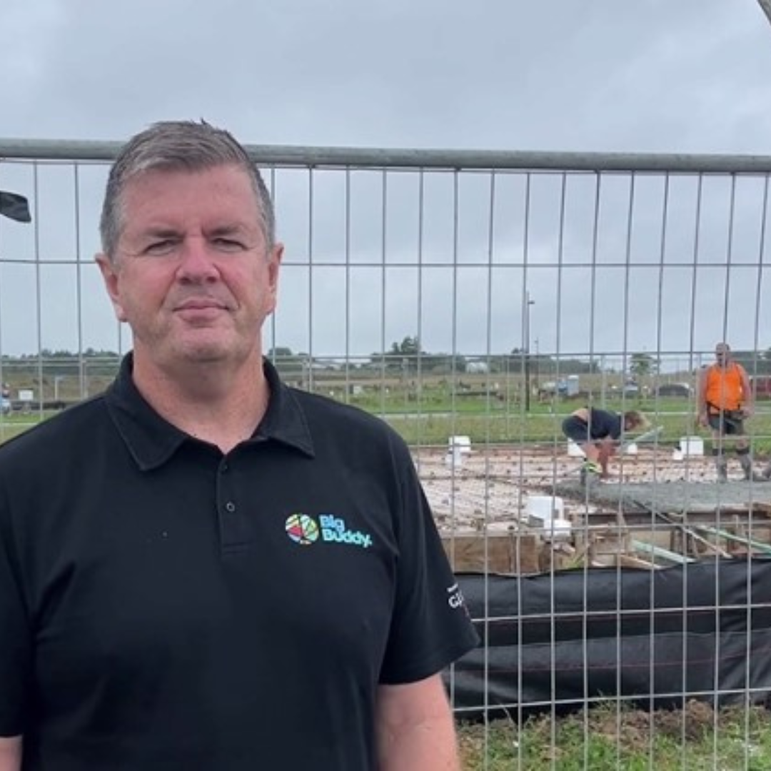 A man standing in front of a constructions site