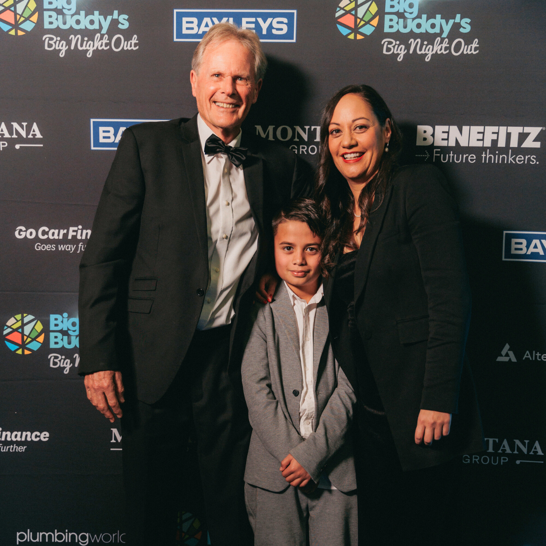 man in black tie, woman in evening dress and young boy in a suit