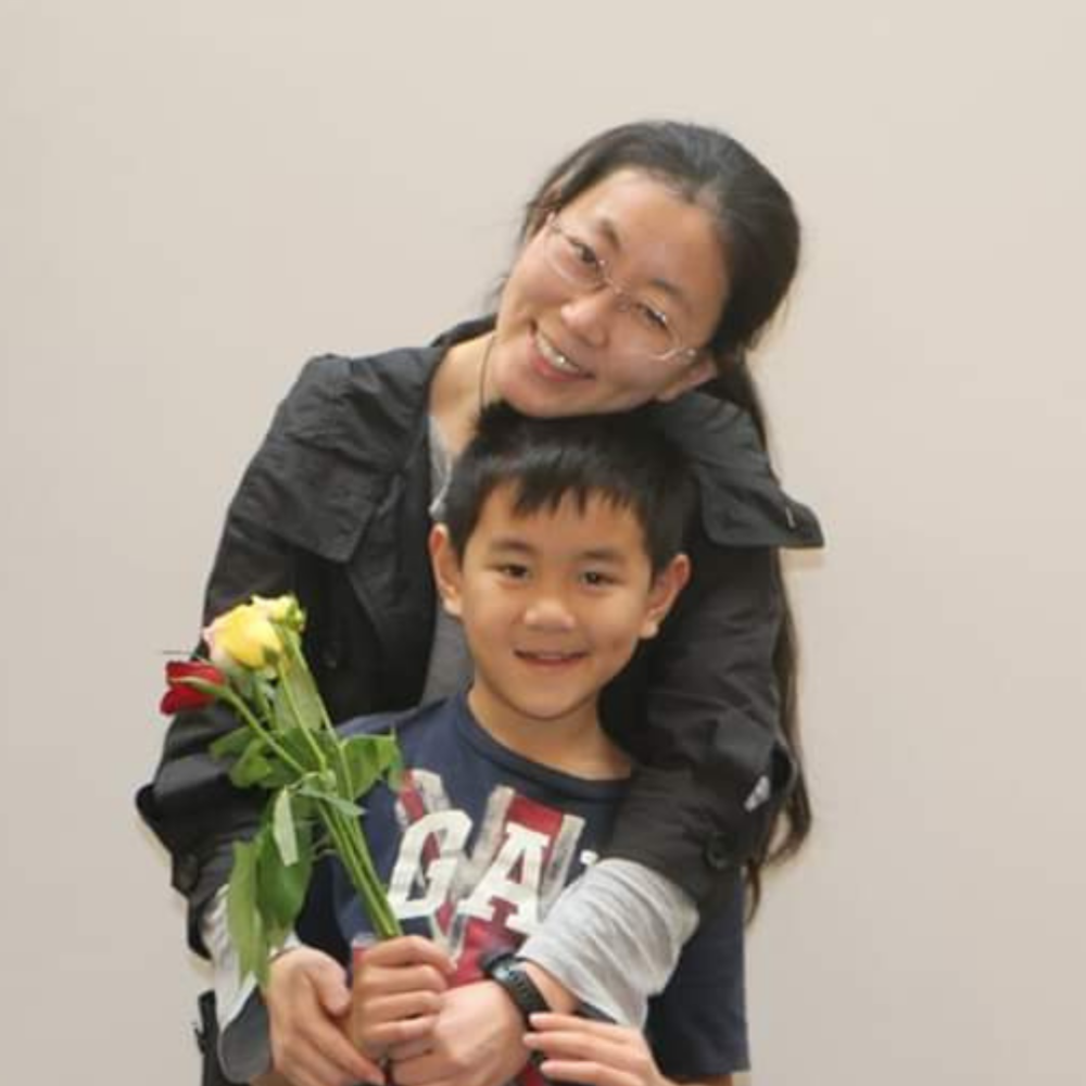 A Little Buddy with his mum. - Woman with boy holding flowers