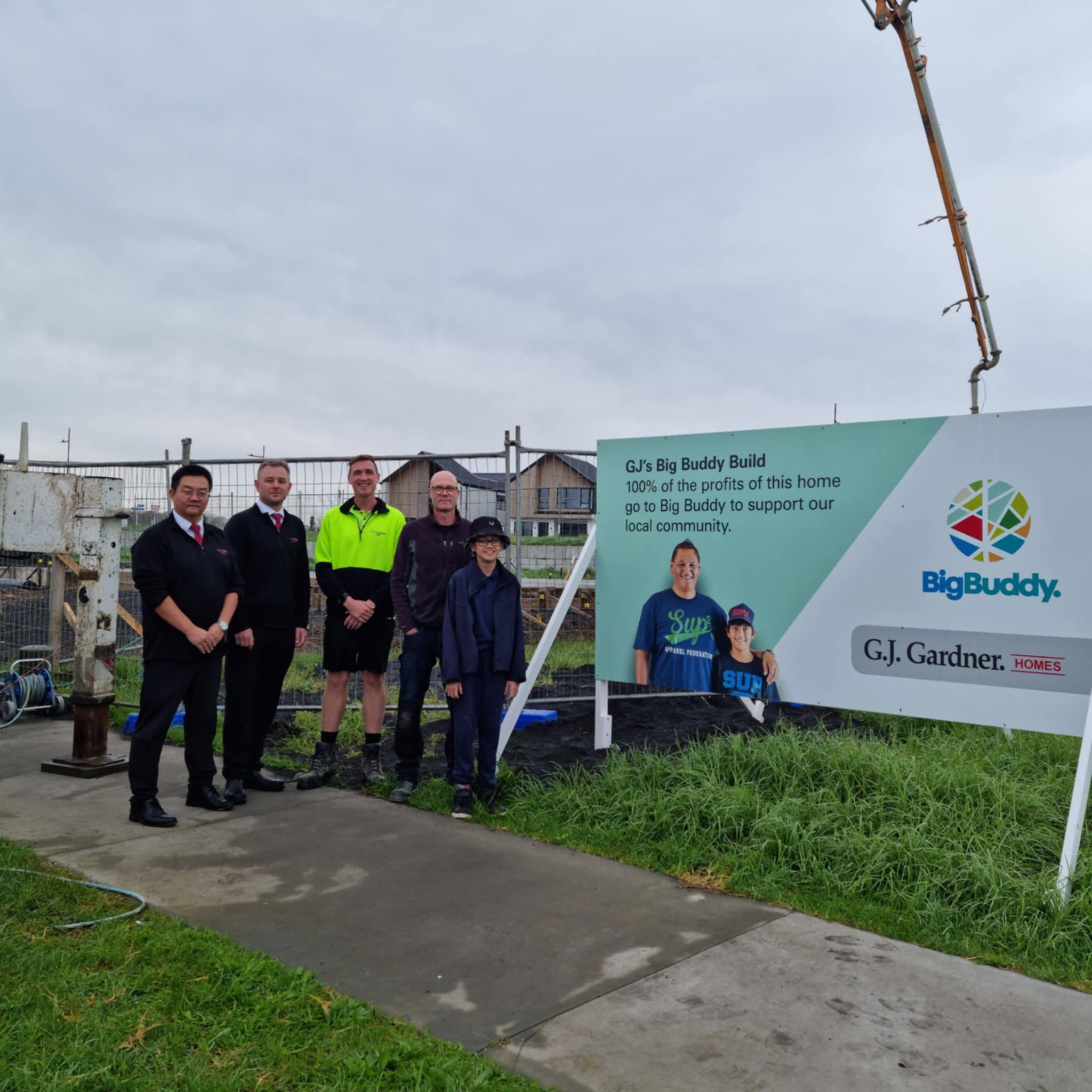 people stand in front of GJ Gardner Sign